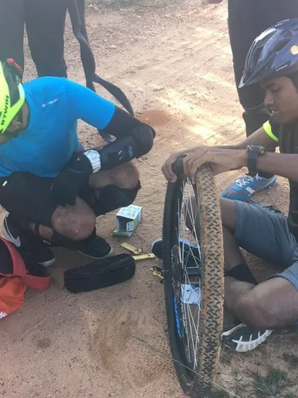 Punctures happen, but we never leave a rider behind. Helping each other out with a quick fix is part of the journey. It's all about teamwork on and off the bike.
