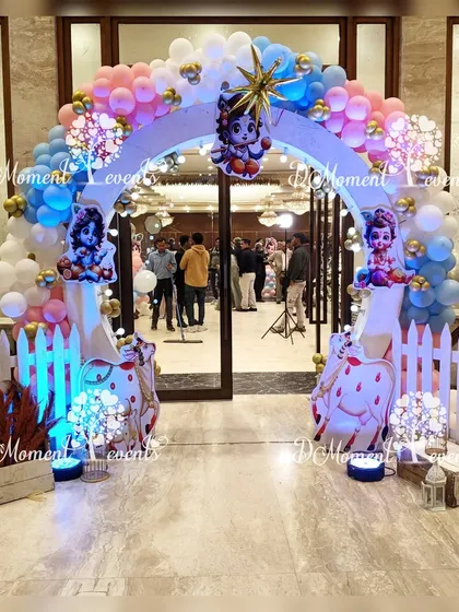 The entrance arch for the Krishna-themed party. The arch is decorated with pastel balloons, star foil balloons, and cutouts of Little Krishna, creating a divine welcome.