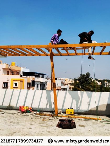 Strong foundations make stunning terraces. My team is at work on a metal frame structure, demonstrating the skill and teamwork required to build a safe and long-lasting pergola.