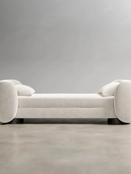 The Divan, a piece of furniture all its own. It can serve as a daybed, a settee, or a chaise lounge, with a timeless bouclé fabric upholstery that gives it a rich, loopy texture.