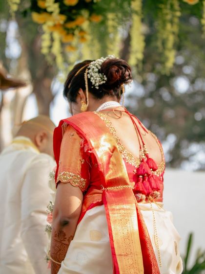 The beauty of a blended cultural wedding. This bride's look is simple and elegant, with minimal makeup that lets her natural radiance shine through, perfectly suited for a beautiful outdoor ceremony.