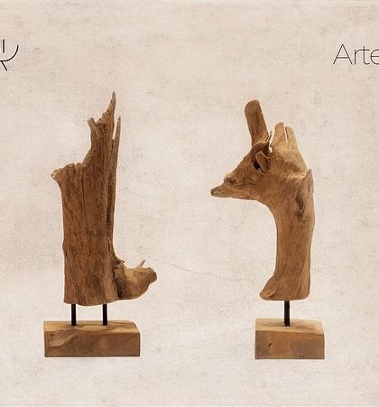 Two abstract artifacts inspired by driftwood. Their raw, organic shapes are preserved and mounted on simple bases, celebrating the untamed beauty of natural wood.