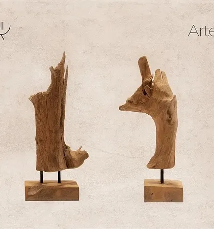 Two abstract artifacts inspired by driftwood. Their raw, organic shapes are preserved and mounted on simple bases, celebrating the untamed beauty of natural wood.