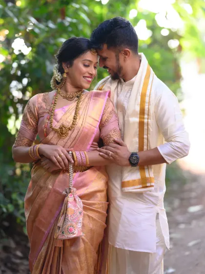 A classic South Indian couple portrait, capturing the elegance of their wedding attire and the warmth of their connection. I use natural light to highlight the rich textures of the silk saree and the intricate details of the jewelry.