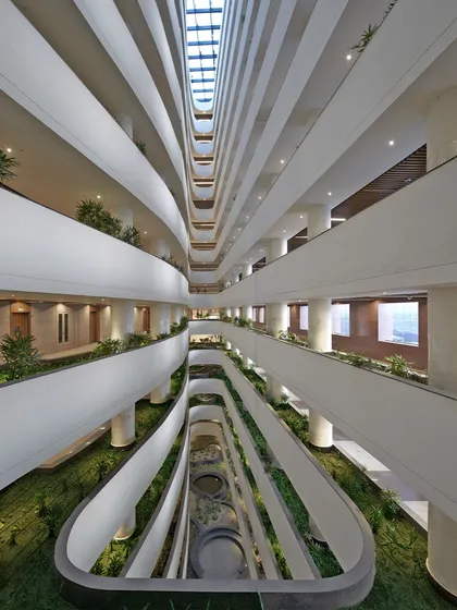 This view down the central spine of the Surat Diamond Bourse reveals how we integrate nature at an immense scale. The staggered atria and landscaped courts act as the building's green lungs, facilitating natural ventilation and creating a comfortable microclimate for the thousands of people who work here daily.