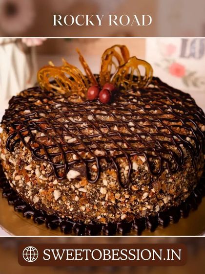 A delicious Rocky Road cake loaded with nuts and drizzled with chocolate, offering a delightful crunch.