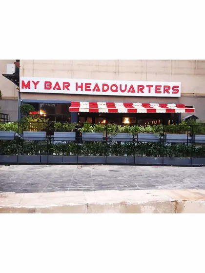 A frontal view of the planter wall at My Bar Headquarters. This functional landscaping solution defines the restaurant's outdoor space while adding significant curb appeal and a fresh, green look to the building's facade.