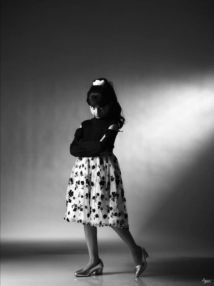 Capturing a bit of attitude and personality. This pose shows her versatility as a young model, able to switch from elegant to playful in an instant.