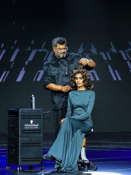 Giving essential energy on stage at the Essential Looks India 2024 event. This shot captures me styling a model's hair, demonstrating techniques for creating soft, elegant curls.