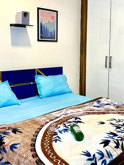 The bedroom features a stylish blue headboard and comes with fresh, clean linens for a comfortable night's sleep.
