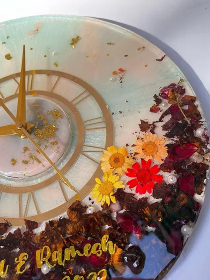 An angled shot of the multi-color flower clock, showing how the light hits the gold flakes and the different layers of resin.