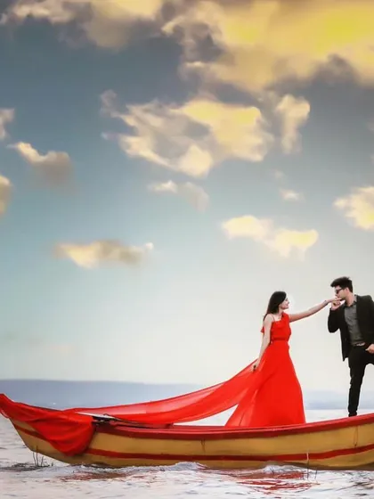 A classic pre-wedding shot that feels like a movie poster. Our red trail gown creates a stunning visual on the boat, making the couple the center of attention. This is a highly sought-after look for rental.