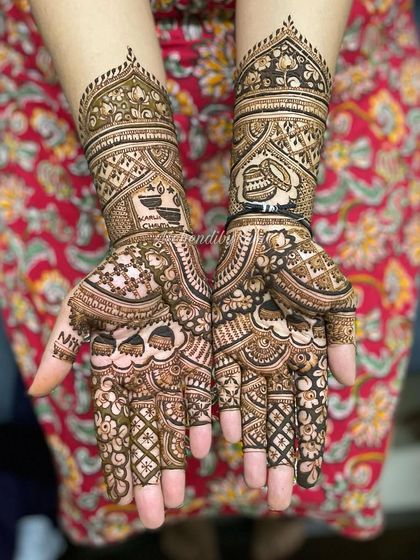 This design incorporates personalized elements like a diya and a peacock. It's a great example of how we can tell a story with your bridal henna.