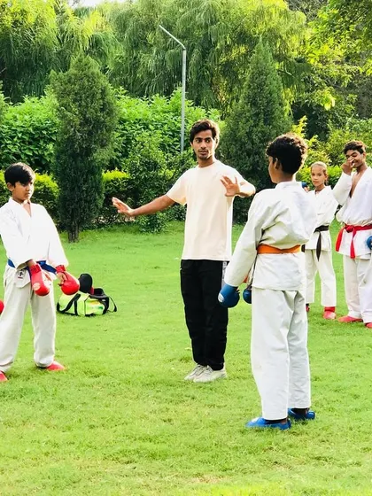 I am instructing students on the nuances of kumite during a fight practice session. Correcting stance and guard is crucial for effective defense and attack.