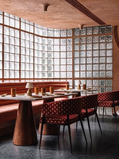 On the upper level of Idylll, a wall of glass blocks allows diffused natural light to fill the space. The design combines a subdued color palette with varied textures to create a prelude for the fine dining experience.