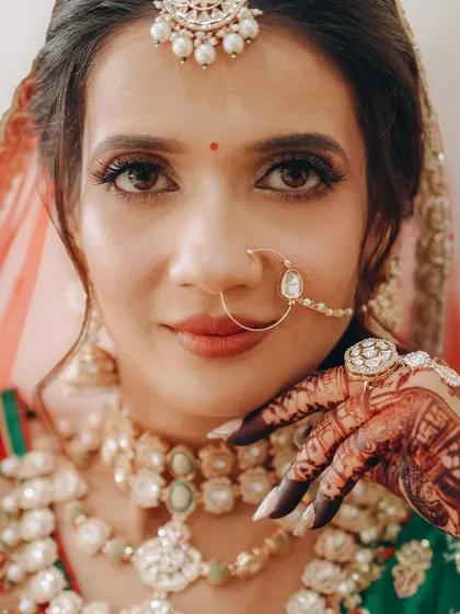 An intimate close-up of this bride's face. I focused on sharp, defined eyes with a winged liner and a perfectly matched lip color to complement her traditional attire.