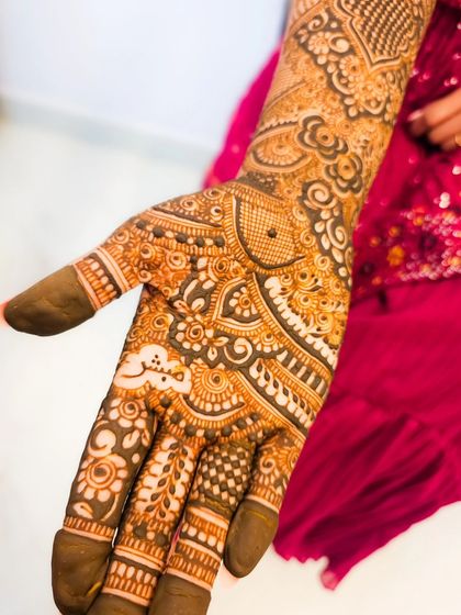 A close-up of the palm, featuring a personalized name in Arabic script.