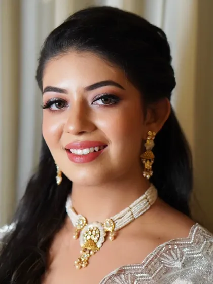 This is my signature 'lit-from-within' glow. For her special day, we focused on creating radiant skin, defined eyes, and a warm, welcoming smile. It's a perfect example of elegant glam that enhances, never overwhelms.