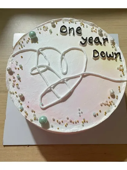 A BTS-themed cake for a true fan, featuring the iconic heart logo. A great way to celebrate a birthday with a touch of K-pop.