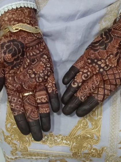 A classic party mehendi design with full finger coverage and a mix of traditional Indian patterns.