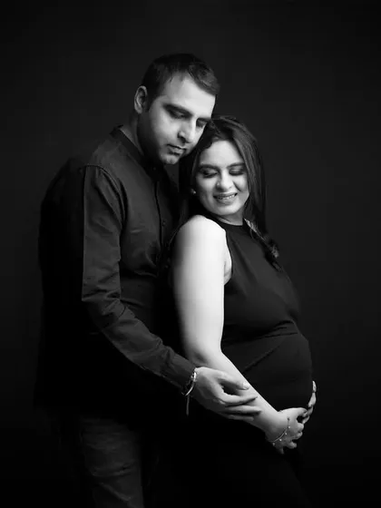 Sometimes the most powerful emotions are captured without color. This classic black and white portrait focuses on the quiet, intimate connection between a couple as they cherish the moments before their family grows.