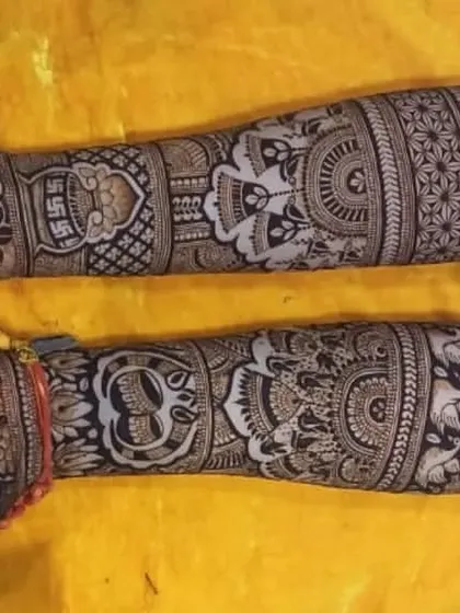 A horizontal layout showing a full arm design. This intricate mehendi is filled with traditional motifs like elephants, peacocks, and floral patterns.
