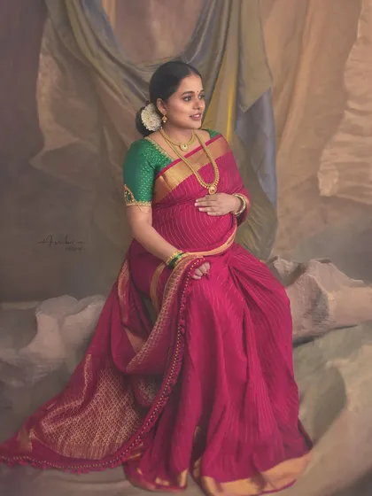 Inspired by the artistic periods of Picasso, this portrait plays with texture and form. The mother-to-be in her pink saree is set against a draped, painted backdrop, creating a unique, abstract, and artistic composition.