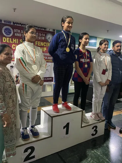 The podium for another girls' event, showcasing the depth of our female fencers' team.