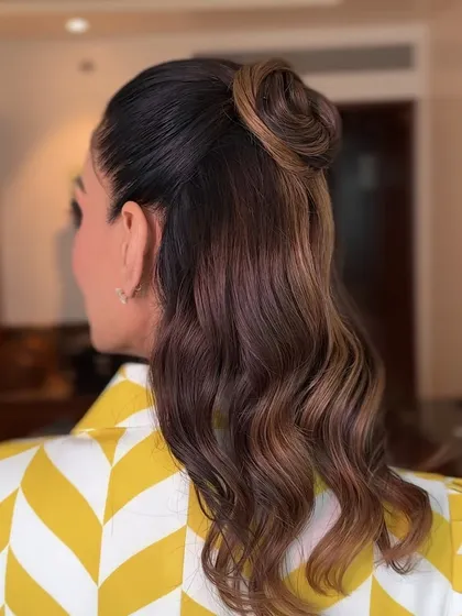 A side view of the trendy top-knot hairstyle, showing how it creates a sleek and fashionable silhouette.