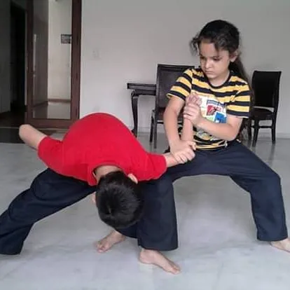 Self-defense is one of the most important skills I teach. Here, two young students practice a basic wrist lock and control technique, learning how to safely neutralize a situation. These practical drills build confidence for real-world scenarios.