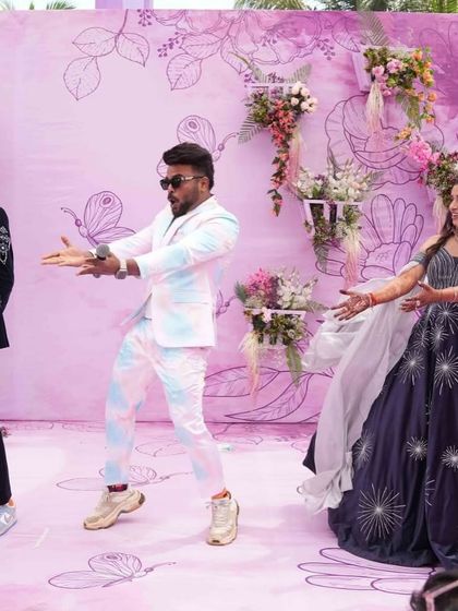 Twisting through life's adventures. A fun dance moment at a pastel-themed carnival party, with a beautiful floral and butterfly backdrop.