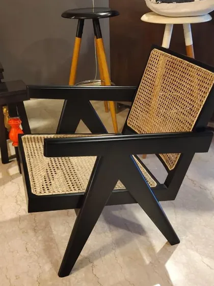Another view of the black-finish Pierre Jeanneret V-leg armchair.