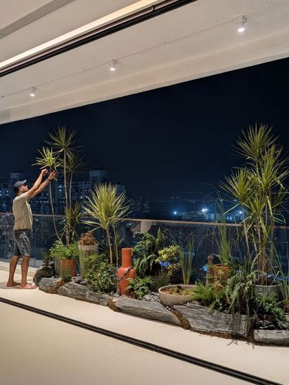 Our co-founder, Angud, giving the finishing touches to an ambitious rock garden on a client's deck. This shows our hands-on approach to making every detail perfect.