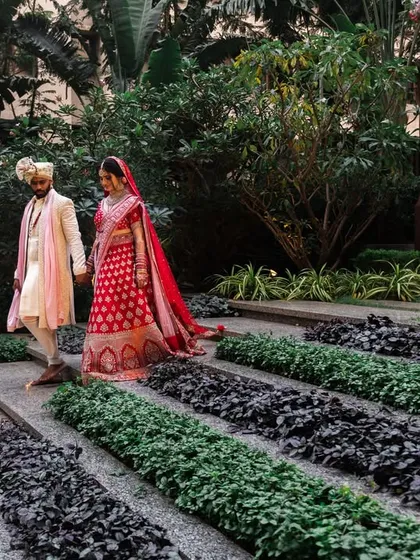 A candid walking shot of the couple in the venue's garden. These moments feel natural and show the couple interacting in a relaxed way.