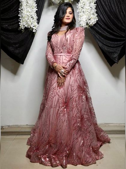 This photo shows how the pink sequin gown looks against a lighter background. It's a versatile dress that shines in any setting, making it a great choice for evening events.