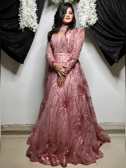 This photo shows how the pink sequin gown looks against a lighter background. It's a versatile dress that shines in any setting, making it a great choice for evening events.