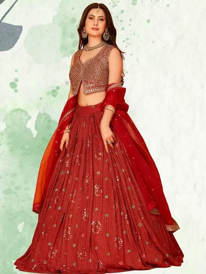 A beautiful red lehenga with a modern twist, featuring a stylish embroidered jacket-style blouse. This piece is perfect for a pre-wedding function or for the contemporary bride.