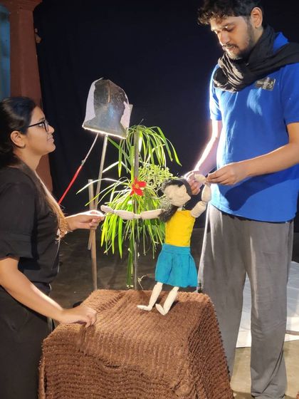 Our team works together to set up a scene for a new project. This shows the collaboration that goes into every performance, from lighting to puppet manipulation.