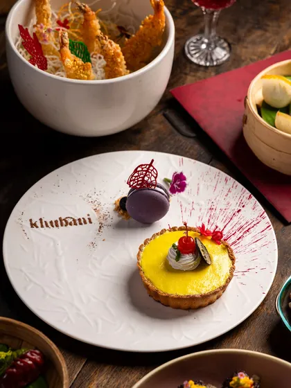 Satisfy your sweet cravings in style. Our decadent desserts, like this beautiful lemon tart with a macaron, are as luxurious as they are delicious. Here, dessert is the star of the show.