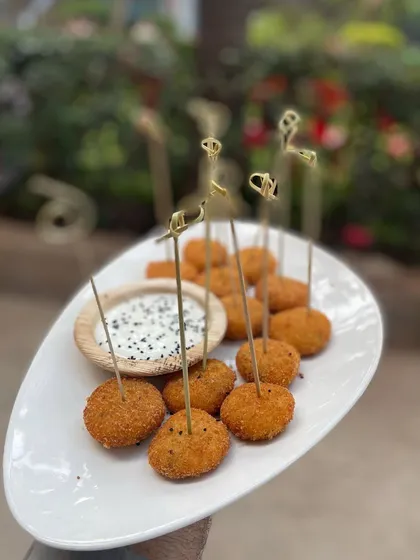 My crispy chicken cutlet bites, served with a creamy dipping sauce and garnished with black sesame seeds. The decorative skewers make them perfect for parties.