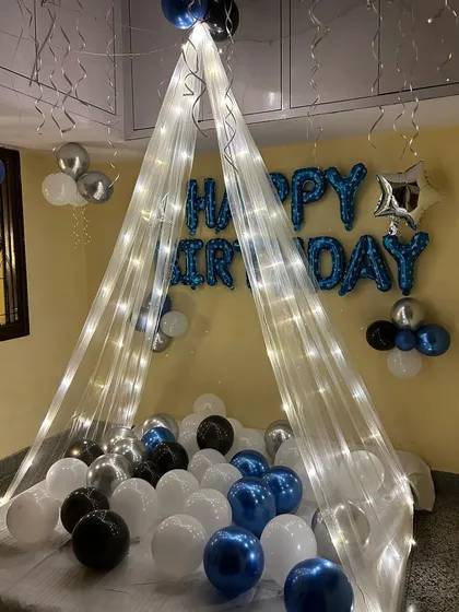 A closer look at the fairy light canopy and "Happy Birthday" foil balloons, perfect for creating a dreamy and festive setting.