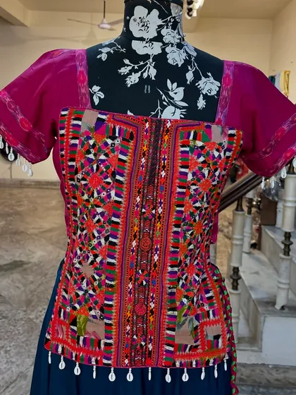 The blouse features intricate, colorful embroidery, a true piece of art.