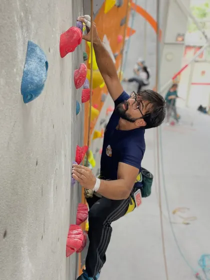 Weekend climbs are the best way to recharge. This climber is focused on a challenging top-rope route.