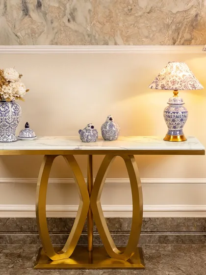 The Solace Sanctuary console table shows how a single piece can transform a space. Its elegant gold-finished stainless steel base has a striking double-ring design, while the artificial marble top provides a durable and beautiful surface. It’s perfect for entryways or living rooms, ready for you to style with lamps, books, or photos.