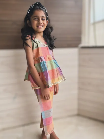 Vibrant hues for a happy heart. This multicolored plaid set is all about fun and playfulness, with a gold border for a touch of elegance.