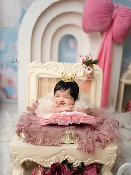 A tiny princess dreaming sweet dreams. This image captures the pure innocence I aim for in my posed newborn sessions, complete with a delicate crown and the softest smile.