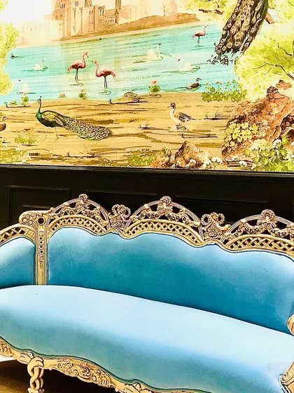 This project was a fusion of retro and contemporary styles. I refurbished the client's existing ornate furniture with bold new fabrics and paired it with a stunning scenic wallpaper to create a truly unique and eclectic living room.