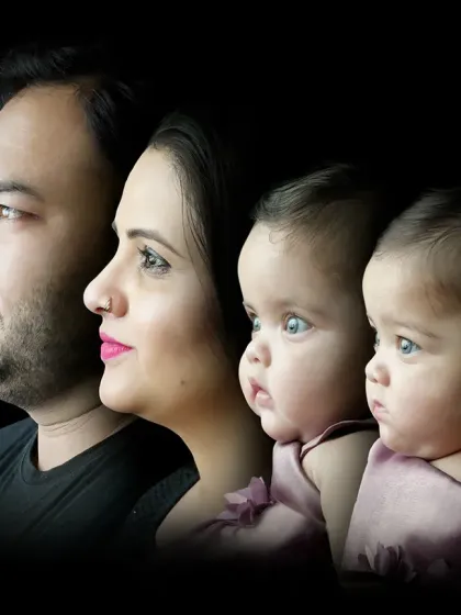 Sometimes, a simple, artistic portrait tells the most powerful story. This dramatic black-themed profile shot of a family with their twin babies is a modern heirloom, focusing purely on their bond.