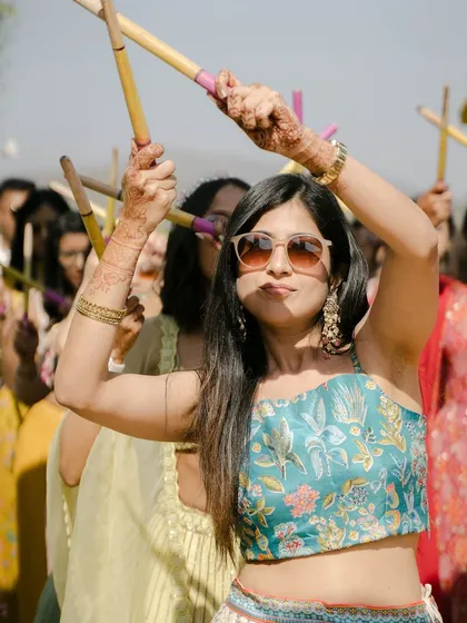Entries are always special. A vibrant Mehendi entry with friends dancing with dandiya sticks.