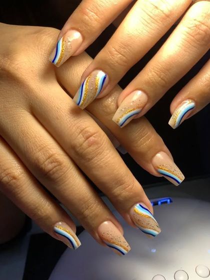 A closer look at the wavy, multi-colored line-work on coffin-shaped nails.
